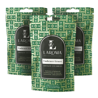 Three green packs of Laroma Embrace Grace Shower Steamers, each featuring a patterned design and labeled as delivering energy, relaxation, and wellness. Each pack contains two shower steamers.