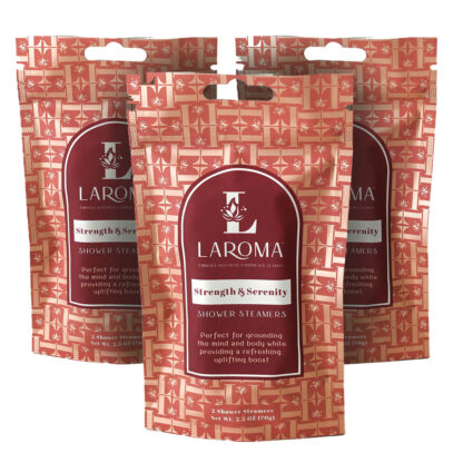 Three red Laroma Strength & Serenity shower steamer packages are displayed upright. The packaging features a white logo, text, and a decorative geometric pattern on a red background.